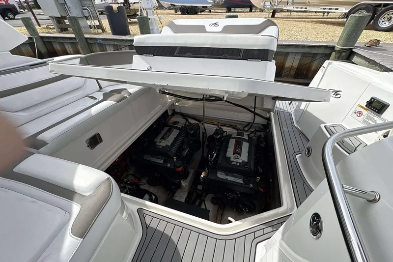 Slide: The Image of Engine compartment of 2020 Monterey 355 Sport Yacht, showcasing dual engines and sleek interior design. - 13