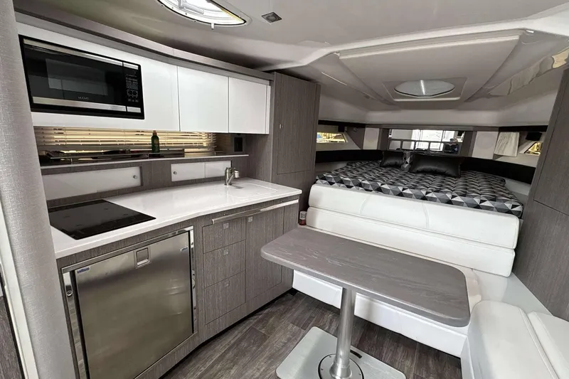 Slide: The Image of Interior of 2020 Monterey 355 Sport Yacht with modern kitchen and cozy sleeping area. - 18