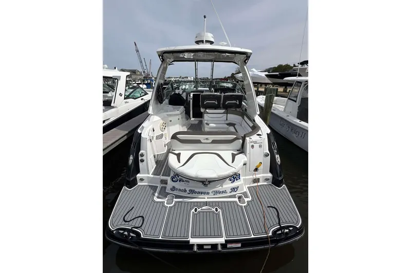 Slide: The Image of 2020 Monterey 355 Sport Yacht docked, showcasing spacious deck and seating area. - 29