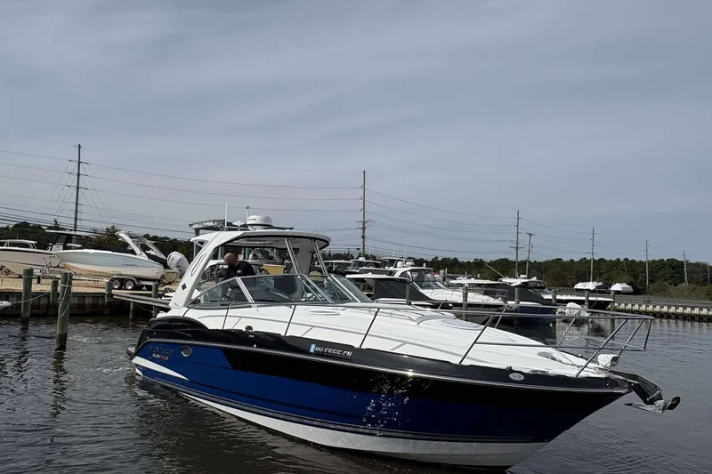 Slide: The Image of 2020 Monterey 355 Sport Yacht docked in a marina, surrounded by other boats. - 4
