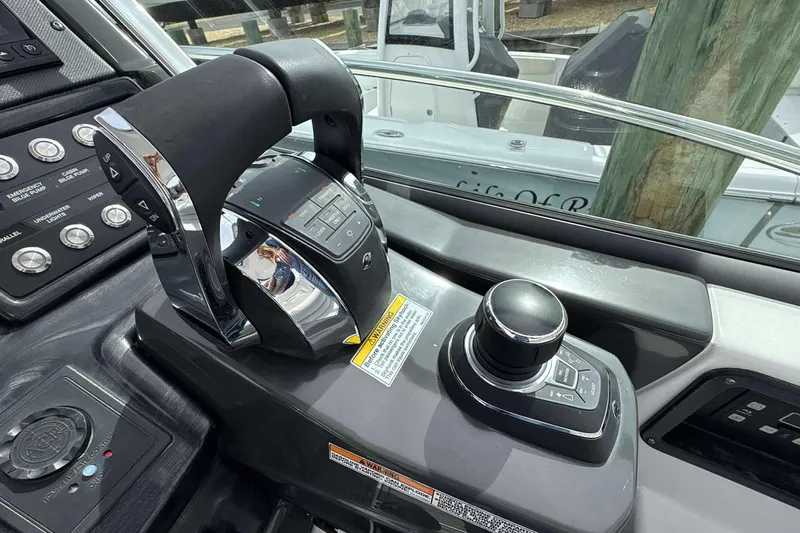Slide: The Image of Control panel of a 2020 Monterey 355 Sport Yacht with throttle and joystick. - 7
