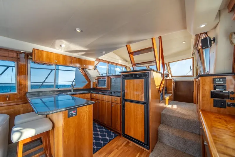 Slide: The Image of Luxurious 2007 Navigator Classic 48 yacht interior with wood finishes and ocean view. - 10