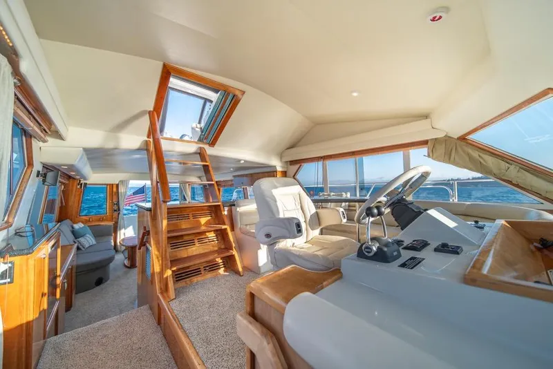 Slide: The Image of Luxurious interior of 2007 Navigator Classic 48 yacht with helm and seating area. - 16