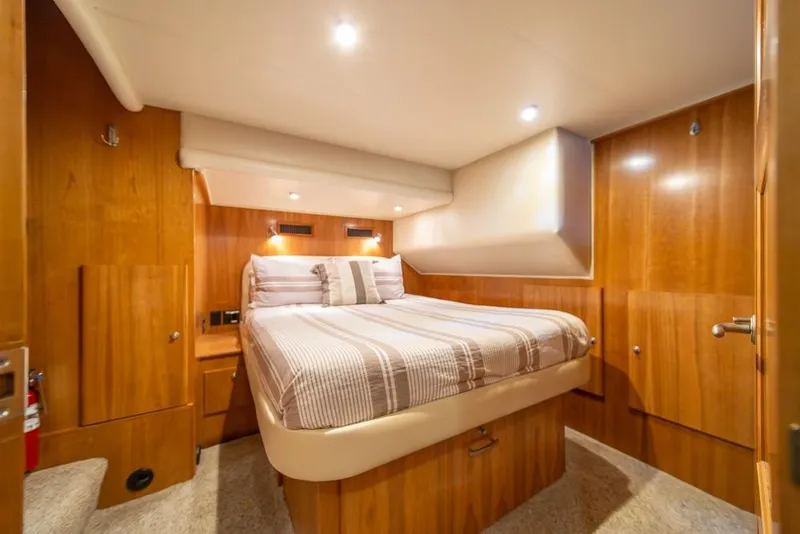 Slide: The Image of Luxurious cabin interior of 2007 Navigator Classic 48 yacht with cozy bed and wooden finish. - 18