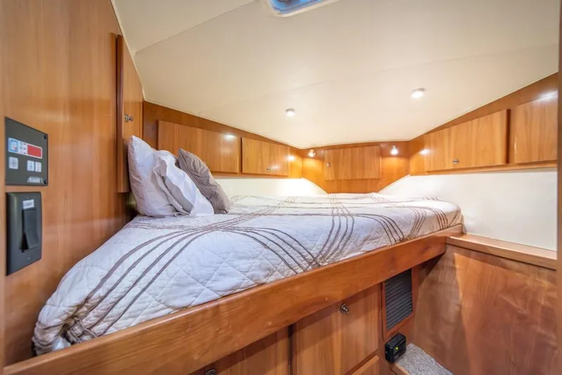Slide: The Image of Cozy cabin interior of 2007 Navigator Classic 48 yacht with wooden finish and comfortable bedding. - 25