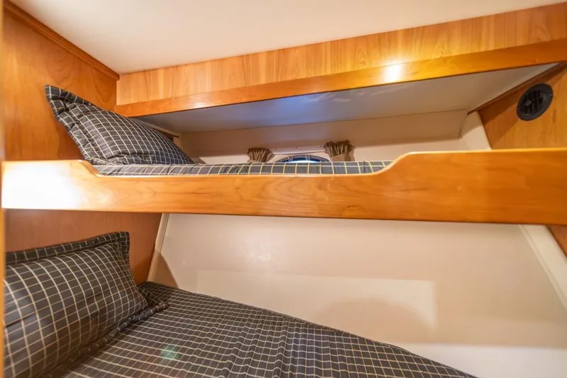 Slide: The Image of Bunk beds with checkered bedding in 2007 Navigator Classic 48 yacht cabin. - 29