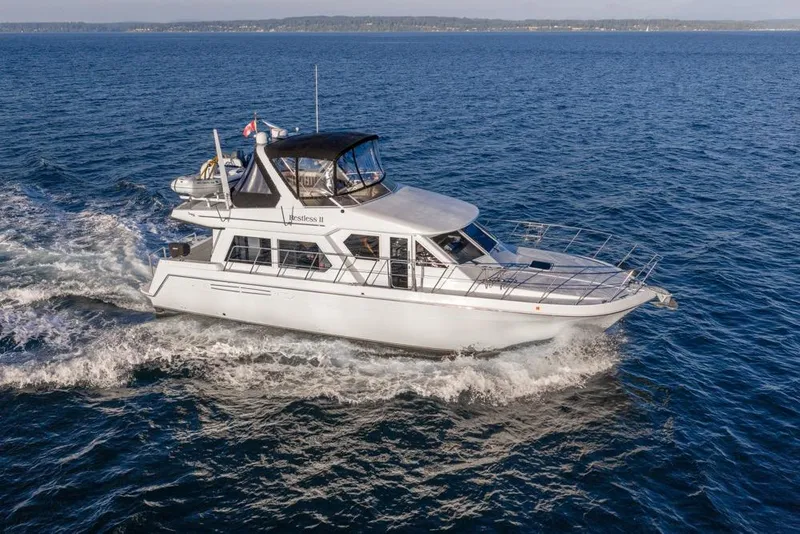 Slide: The Image of 2007 Navigator Classic 48 yacht cruising on open water. - 3