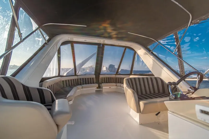 Slide: The Image of Luxurious interior of 2007 Navigator Classic 48 yacht with panoramic windows and striped seating. - 31