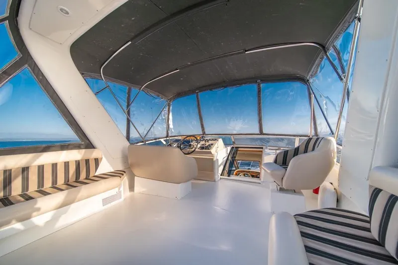 Slide: The Image of Interior of 2007 Navigator Classic 48 yacht with striped seating and panoramic windows. - 32