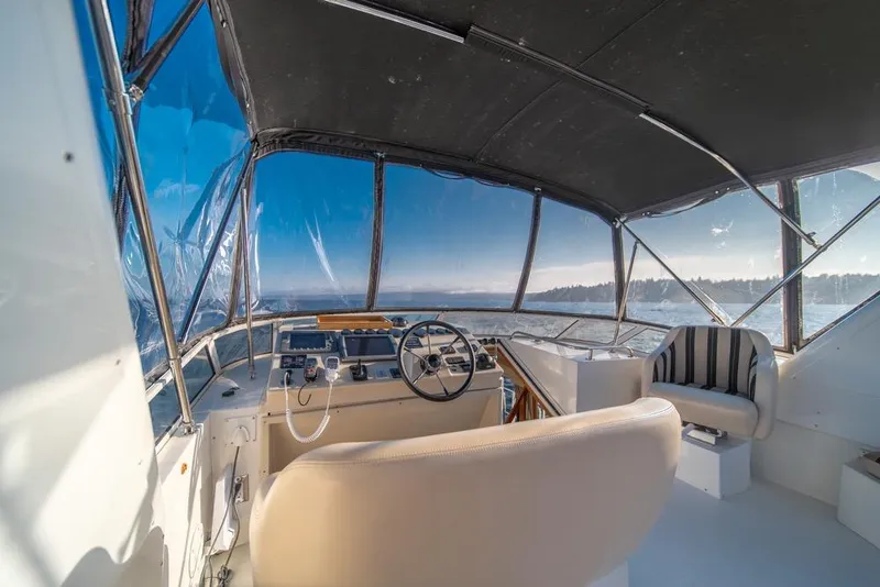 Slide: The Image of Interior view of 2007 Navigator Classic 48 yacht cockpit with steering wheel and seating. - 34