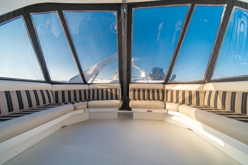 Slide: The Image of Luxurious interior of 2007 Navigator Classic 48 yacht with striped seating and panoramic windows. - 36