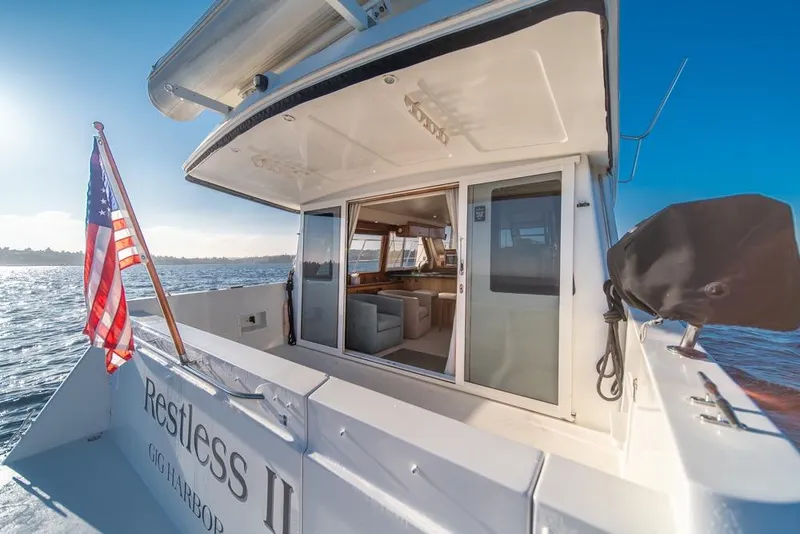 Slide: The Image of 2007 Navigator Classic 48 yacht with American flag, open cabin, and ocean view. - 39