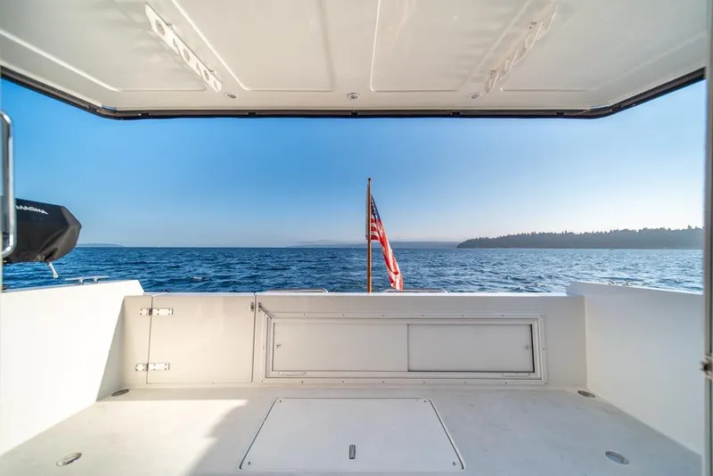 Slide: The Image of 2007 Navigator Classic 48 yacht deck with ocean view and American flag. - 40