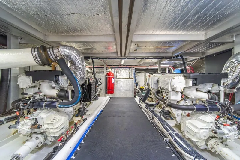 Slide: The Image of Engine room of 2007 Navigator Classic 48 yacht, featuring dual engines and metallic insulation. - 41