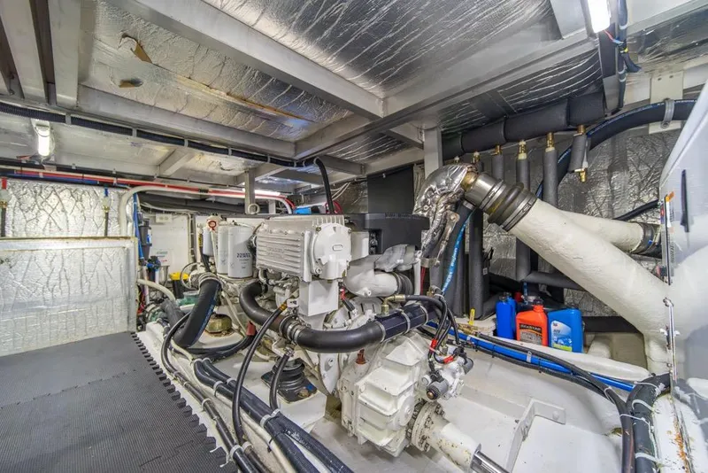 Slide: The Image of Engine room of 2007 Navigator Classic 48 yacht, featuring complex machinery and piping. - 43