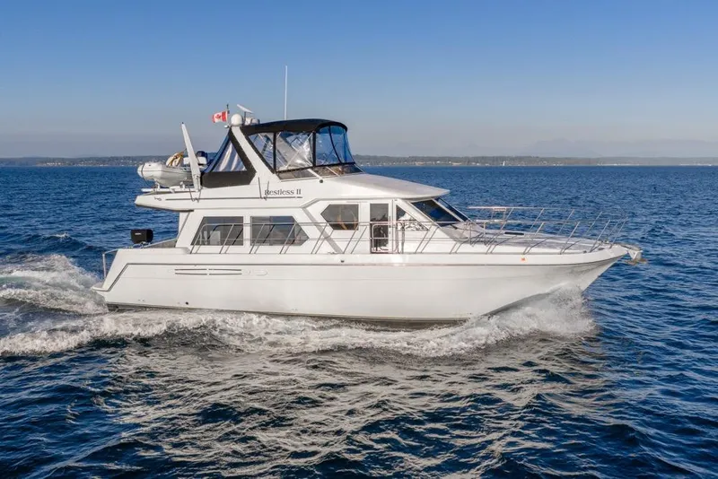 Slide: The Image of 2007 Navigator Classic 48 yacht cruising on open water under clear skies. - 51