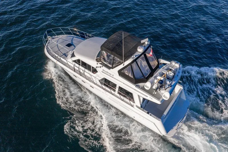 Slide: The Image of Aerial view of 2007 Navigator Classic 48 yacht cruising on open water. - 6