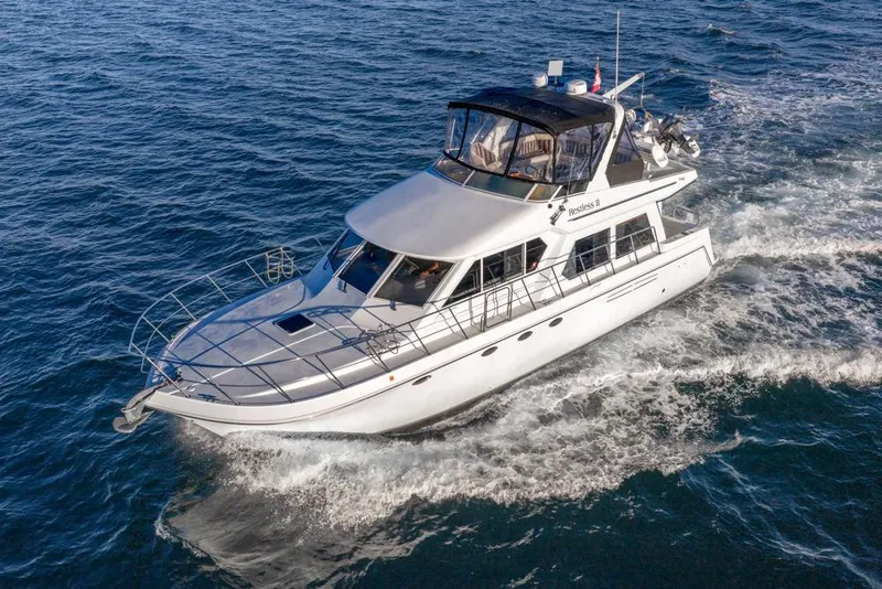 Slide: The Image of 2007 Navigator Classic 48 yacht cruising on open water, showcasing sleek design and luxury. - 7