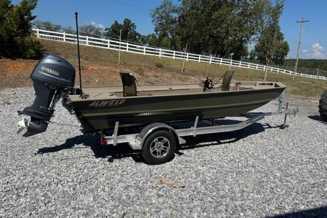 Slide: The Image of 2025 Alweld 1856PF boat on trailer with Yamaha outboard motor, parked on gravel. - 3