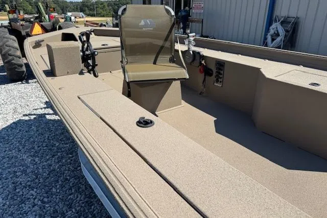 Slide: The Image of 2025 Alweld 1856PF boat with seating, parked on gravel near a building. - 6