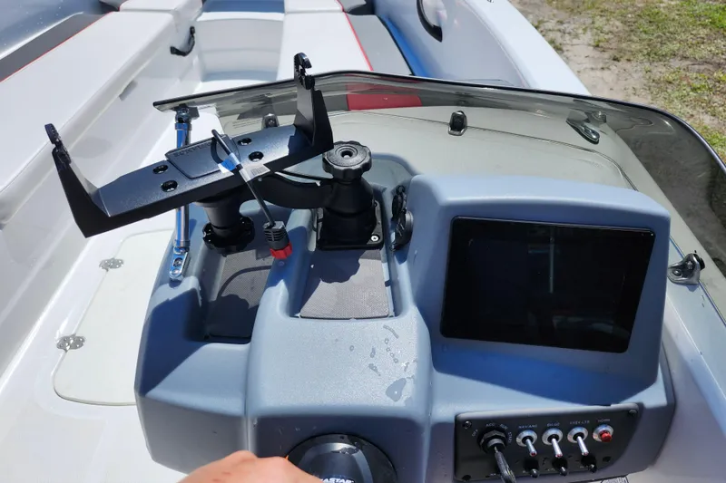 Slide: The Image of 2023 Tahoe T18 boat dashboard with controls and display screen. - 13