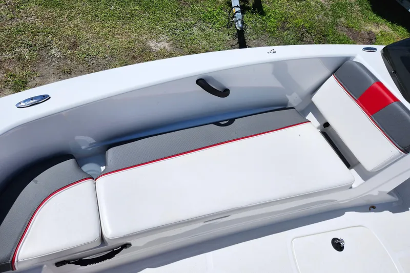 Slide: The Image of 2023 Tahoe T18 boat interior with white and gray seating, red accents. - 17