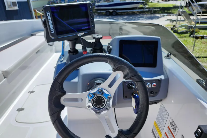 Slide: The Image of 2023 Tahoe T18 boat dashboard with steering wheel and navigation system. - 24