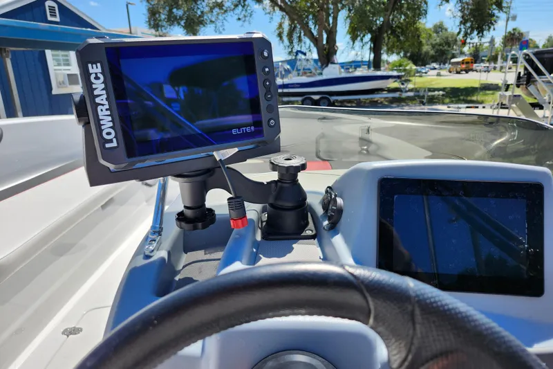 Slide: The Image of 2023 Tahoe T18 boat dashboard with Lowrance Elite fishfinder and steering wheel. - 25
