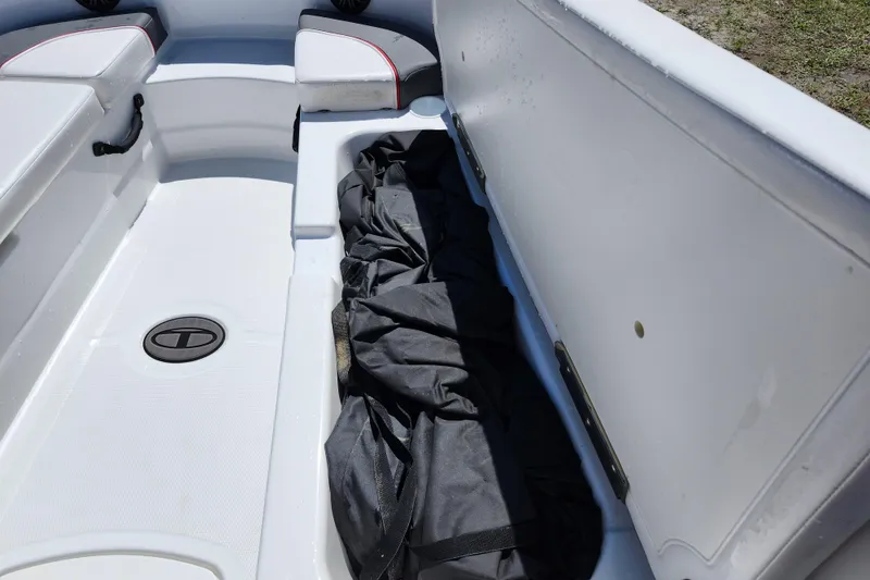 Slide: The Image of 2023 Tahoe T18 boat interior storage compartment with black cover. - 8