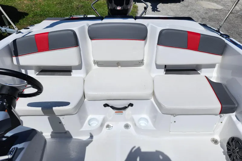 Slide: The Image of 2023 Tahoe T18 boat interior with white and gray seating, red accents. - 9