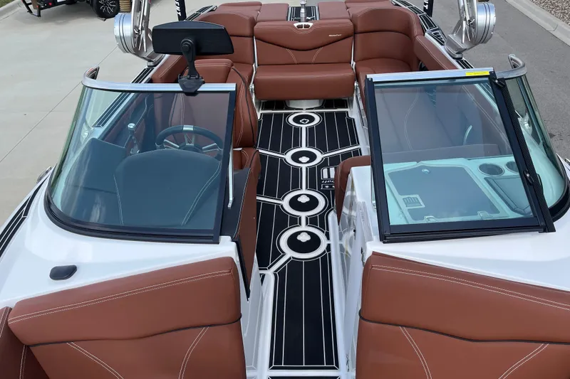 Slide: The Image of 2020 MasterCraft XT23 boat interior with brown seating and black flooring. - 13