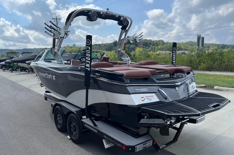 Slide: The Image of 2020 MasterCraft XT23 boat on trailer, sleek design, parked outdoors under cloudy sky. - 6