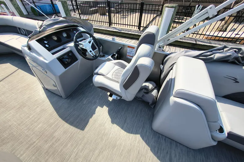 Slide: The Image of 2023 Bennington 25 LSRC boat interior with steering wheel and seating. - 14