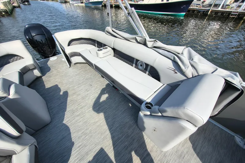 Slide: The Image of 2023 Bennington 25 LSRC pontoon boat interior with plush seating and cup holders. - 7