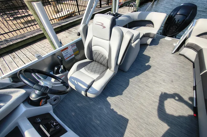 Slide: The Image of 2023 Bennington 25 LSRC boat interior with luxurious seating and modern steering console. - 8