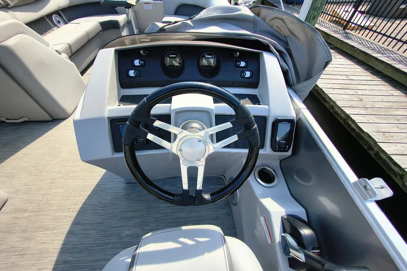 Slide: The Image of 2023 Bennington 25 LSRC boat dashboard with steering wheel and controls. - 13