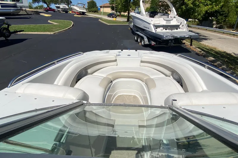 Slide: The Image of 2007 Crownline 252 EX boat with spacious seating, parked on a trailer. - 11