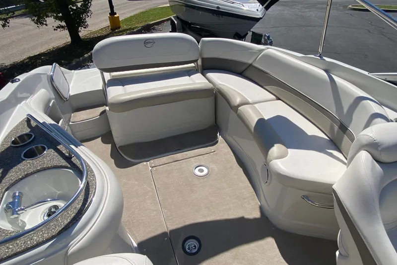 Slide: The Image of 2007 Crownline 252 EX boat interior with spacious seating and built-in cup holders. - 7