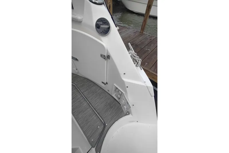 Slide: The Image of 2017 Rinker EX 320 boat interior with control panel and dock view. - 15