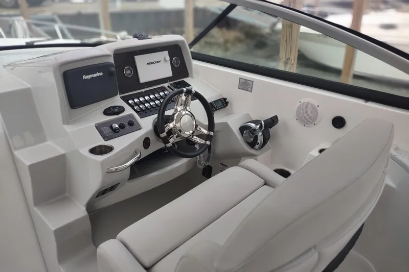 Slide: The Image of 2017 Rinker EX 320 boat cockpit with steering wheel and control panel. - 19