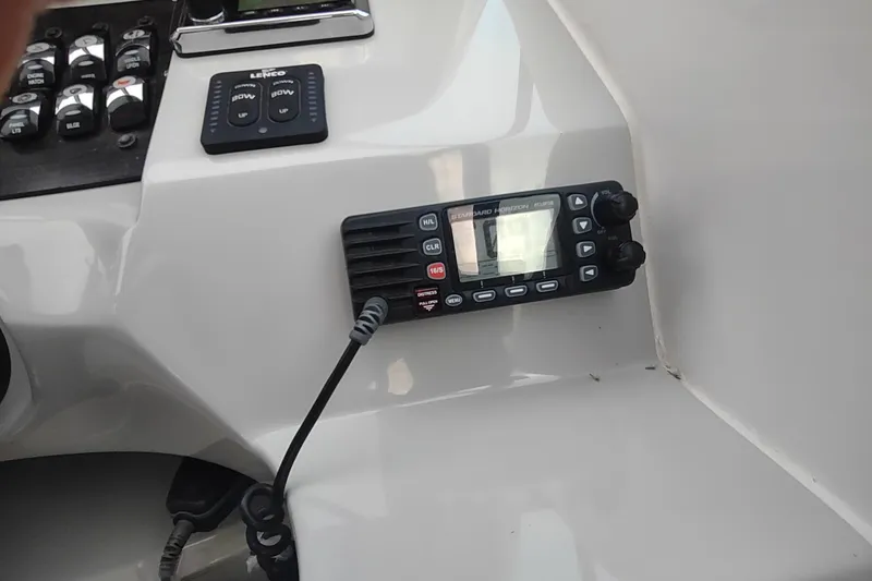 Slide: The Image of Control panel of a 2017 Rinker EX 320 boat with radio and switches. - 22