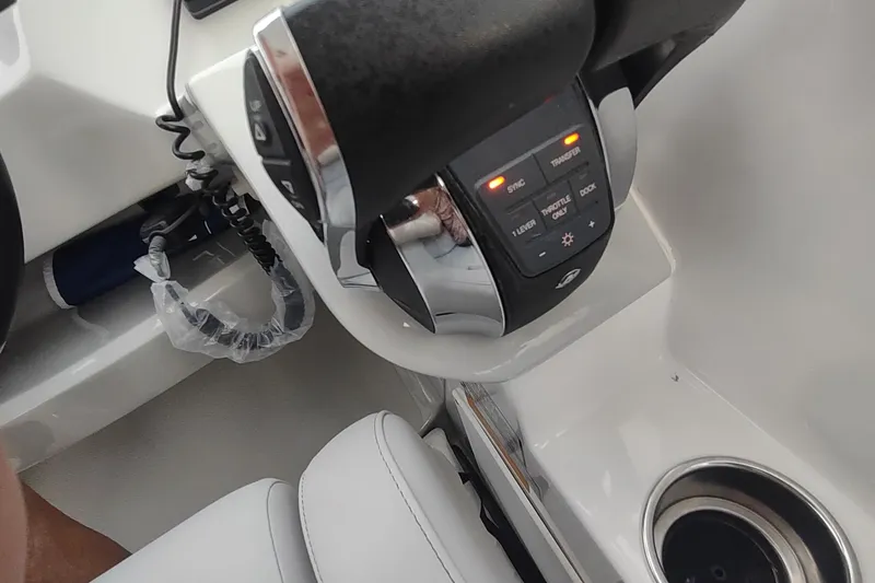 Slide: The Image of 2017 Rinker EX 320 boat throttle controls with illuminated buttons and cup holder. - 23