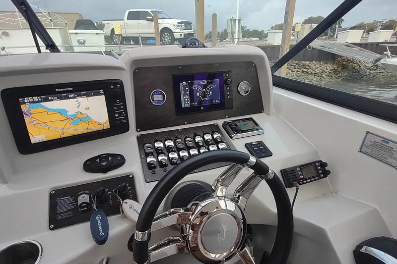Slide: The Image of 2017 Rinker EX 320 boat dashboard with navigation and control systems. - 26