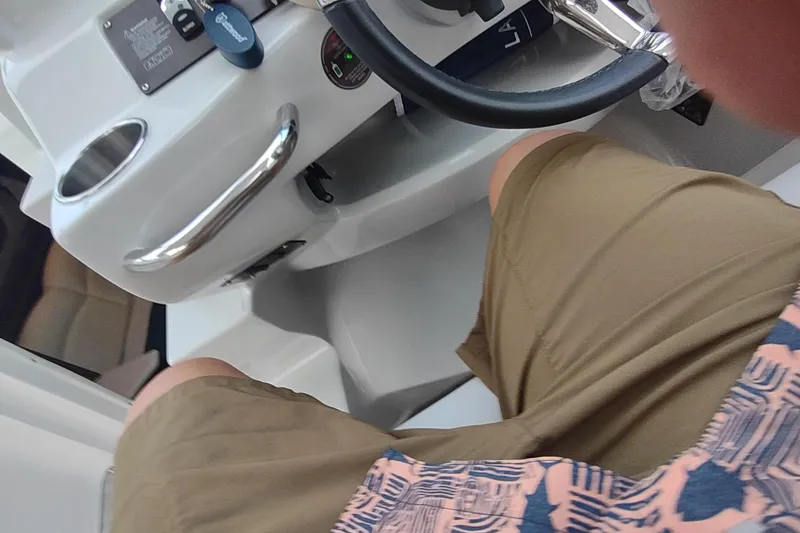 Slide: The Image of Interior view of a 2017 Rinker EX 320 boat cockpit with steering wheel. - 27