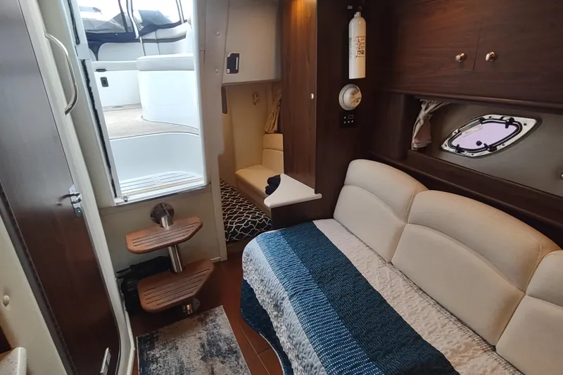 Slide: The Image of 2017 Rinker EX 320 cabin interior with cozy seating and modern design. - 34