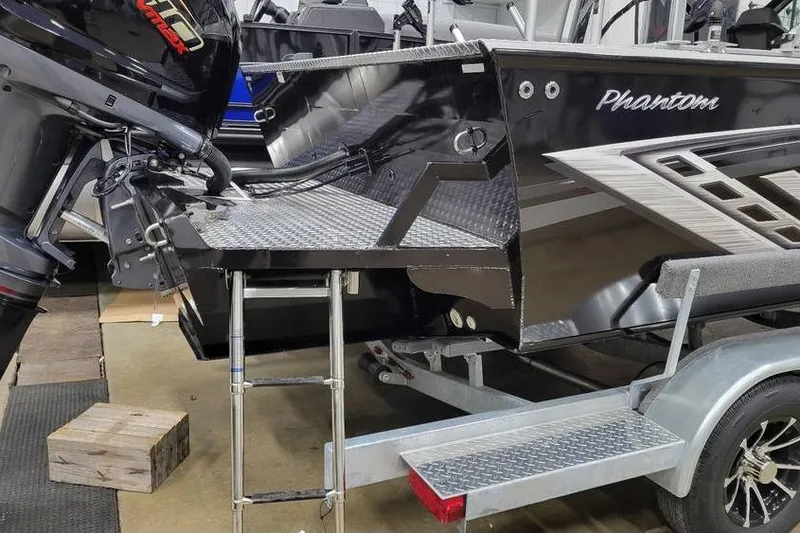Slide: The Image of 2025 Smoker Craft Phantom 20 X2 OS boat on trailer, featuring outboard motor and ladder. - 10