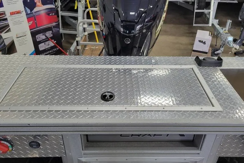 Slide: The Image of 2025 Smoker Craft Phantom 20 X2 OS boat with diamond plate deck detail. - 12