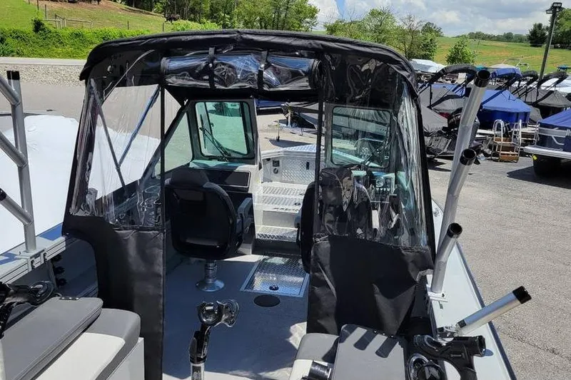Slide: The Image of 2025 Smoker Craft Phantom 20 X2 OS boat interior with seating and rod holders. - 14