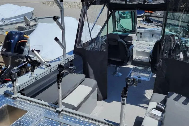 Slide: The Image of 2025 Smoker Craft Phantom 20 X2 OS boat interior with fishing rod holders and seating. - 15