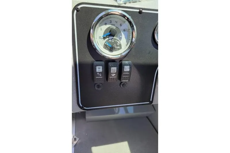 Slide: The Image of Dashboard of 2025 Smoker Craft Phantom 20 X2 OS boat with gauges and switches. - 17
